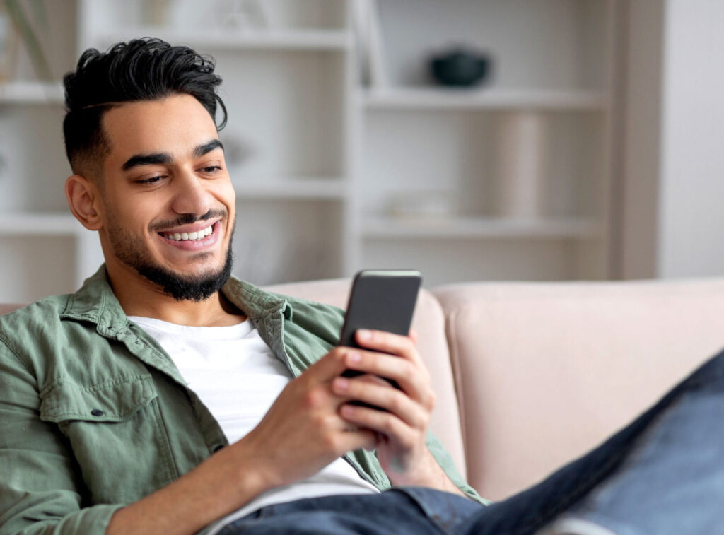 Male college student looking at phone